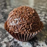 Close-up view of a delicious Brazilian brigadeiro in a paper cup.