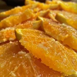 Close-up of Tender ao Molho de Laranja e Mel, showcasing juicy meat and a vibrant orange sauce.
