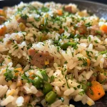 Close-up of a colorful dish of arroz especial com legumes, showcasing vibrant ingredients.