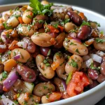 Close-up of roasted assorted legumes featuring zucchini, carrot, and beet.