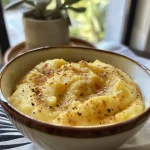 Close-up of a creamy, sweet purple sweet potato puree in a bowl with a smooth texture.
