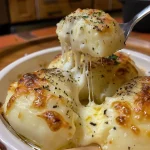 Close-up of a creamy pasta dish topped with four types of cheese.