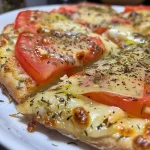 Close-up of a crispy and golden Pizza Frita with melted cheese and toppings.