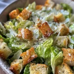 Close-up of a classic Caesar salad with fresh romaine lettuce, croutons, and Parmesan.