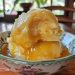 Close-up of a creamy passion fruit cake with a side view, showcasing its moist texture.