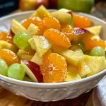 Salada de frutas colorida com abacaxi, bananas e uvas.