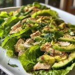 Close up of turkey and avocado lettuce wraps arranged on a plate.