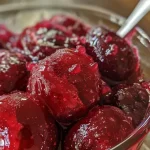 Close-up of vibrant cherry ice pops with a glossy finish.
