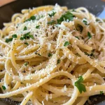 Close up of cheesy garlic Parmesan spaghetti with herbs.