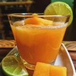 ['Suco de melancia com limão em um copo, decorado com hortelã.', 'Close-up de um copo de suco de melancia com limão, rodeado por cubos de gelo.', 'Bebida refrescante de suco de melancia com limão, apresentada em um copo transparente.', 'Suco de melancia com limão com gotas de orvalho, decorado com folhas de hortelã.']